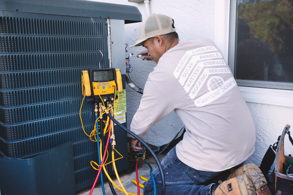 Our repair guy installing a new heating and air conditioning system at a home in Menifee.