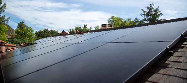 New solar panels installed on shingle roof with new tiles.